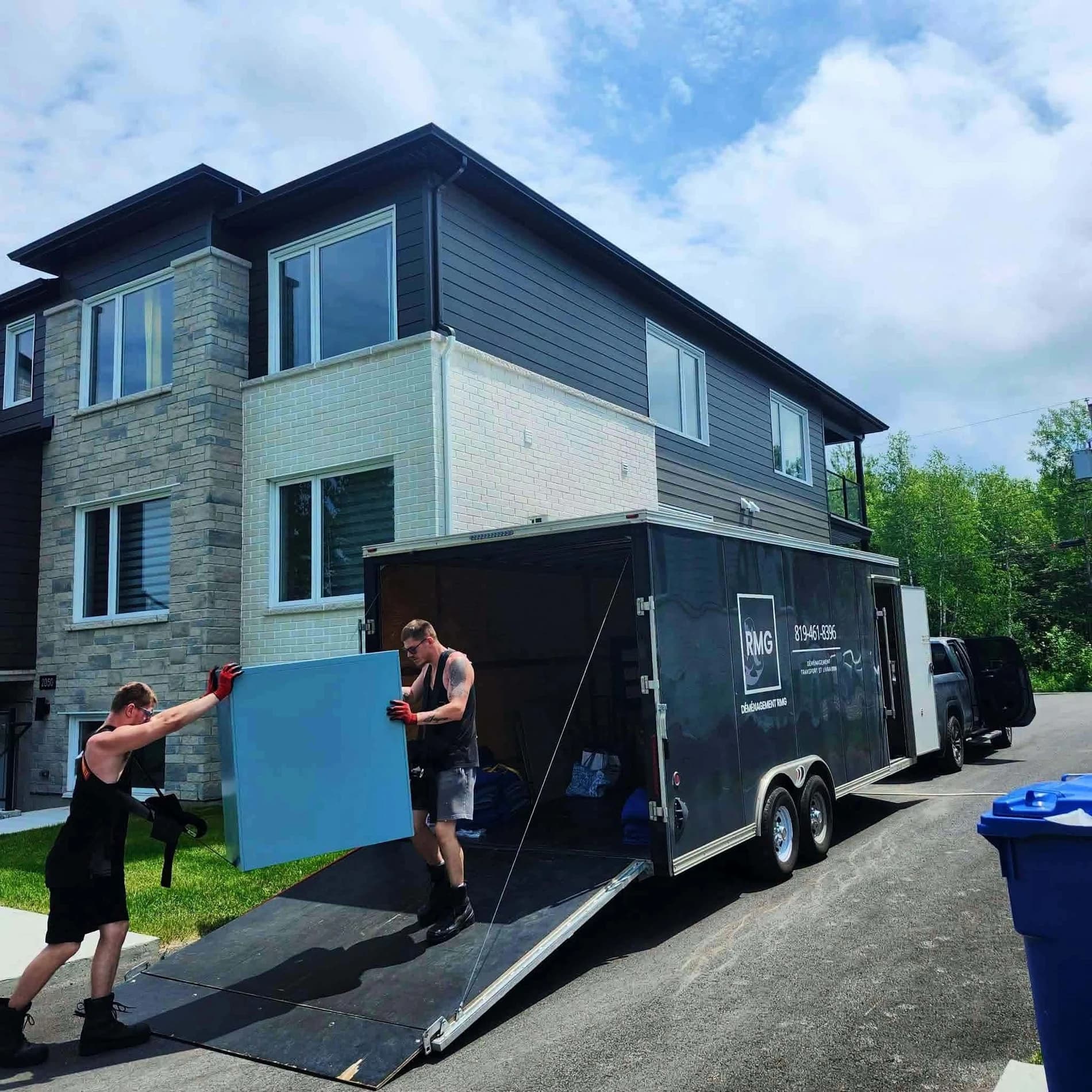 RMG movers working beside an open trailer