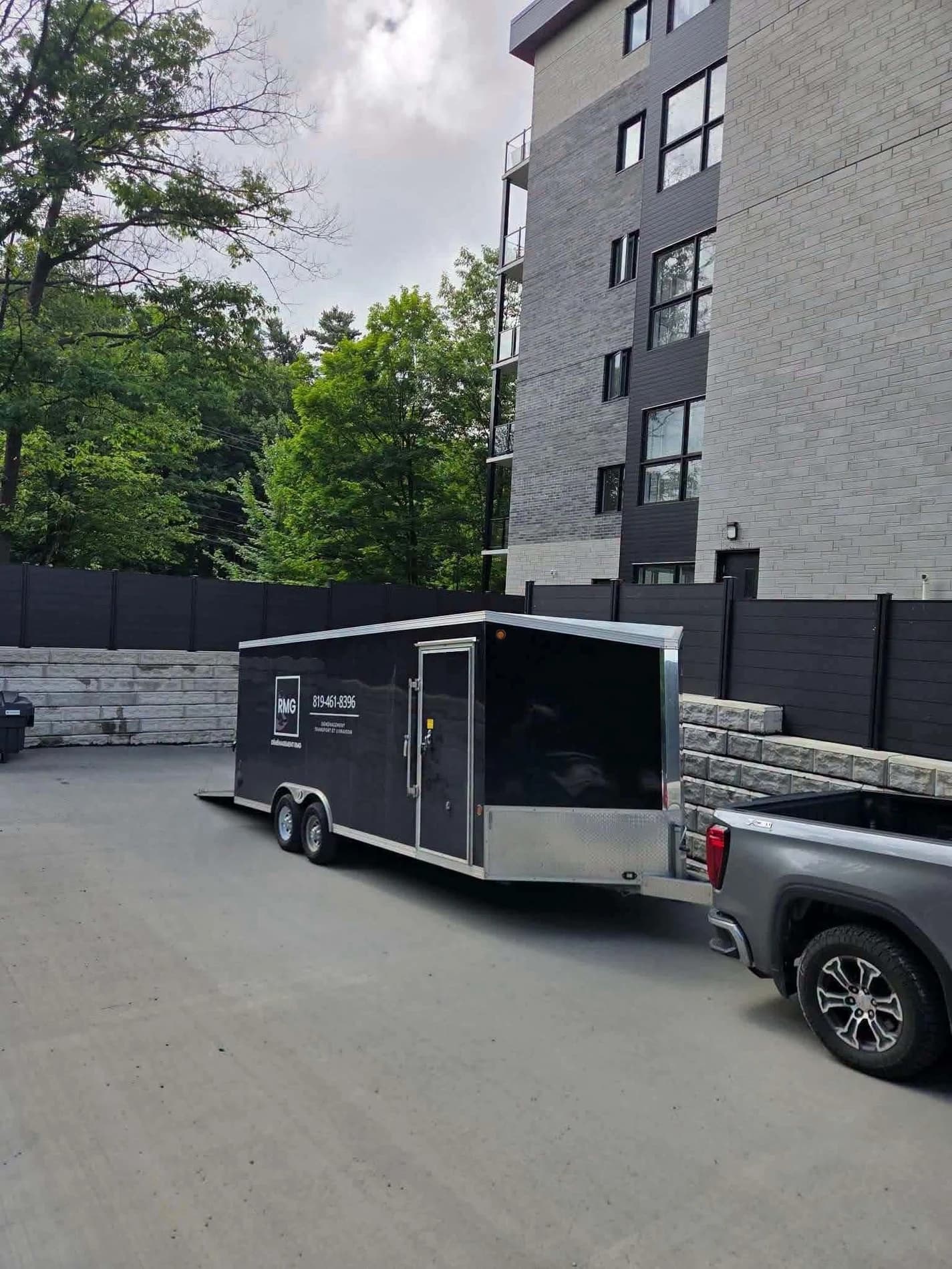 RMG black enclosed trailer at a moving job